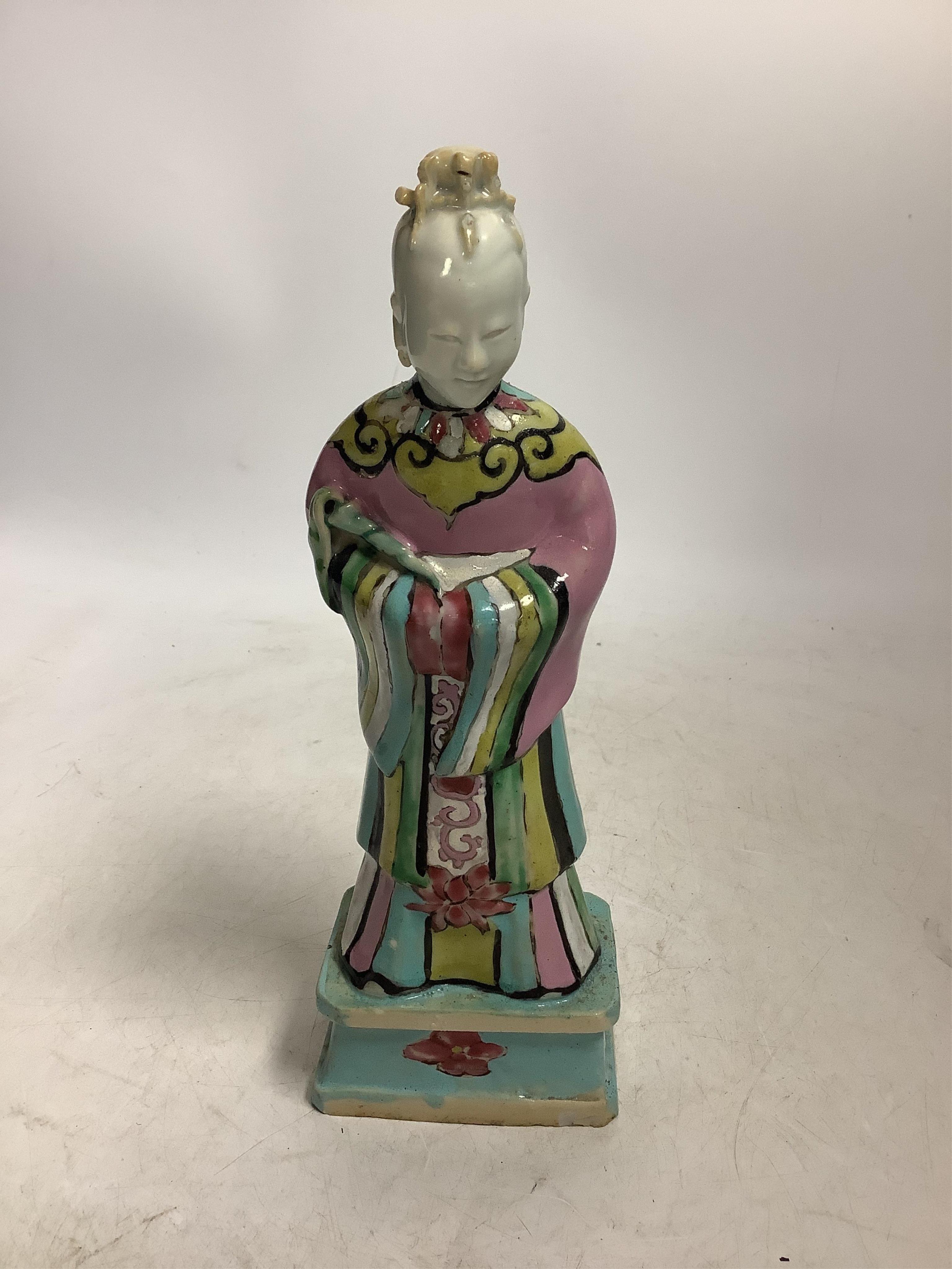 A Chinese enamelled porcelain figure of an immortal, Qianlong period. Condition - head glued